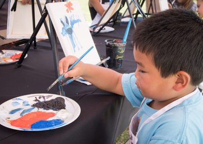 boy coloring painting at 2021 chalk and cheers event